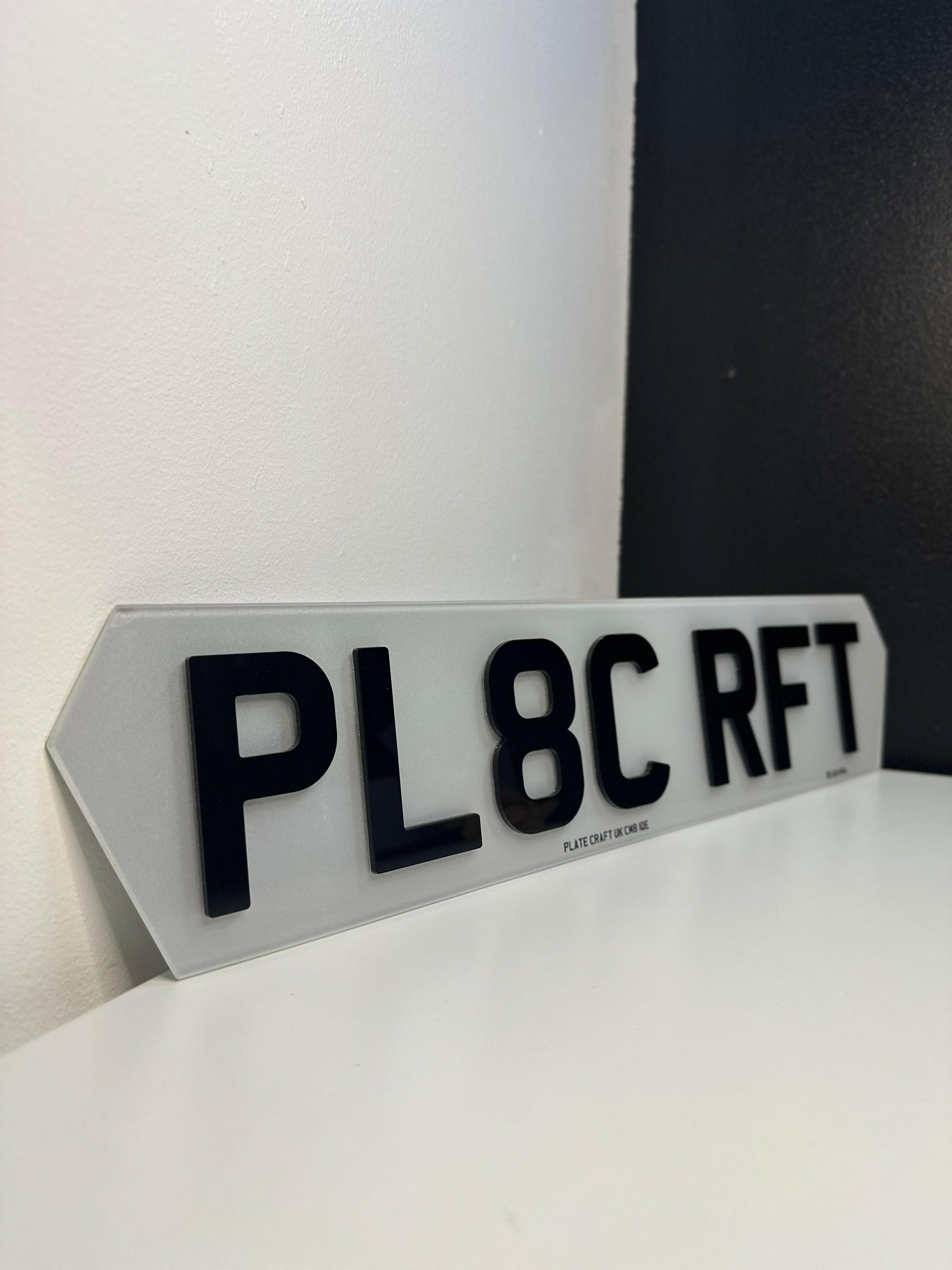 Close-up of custom hex-shaped number plate featuring bevelled lettering