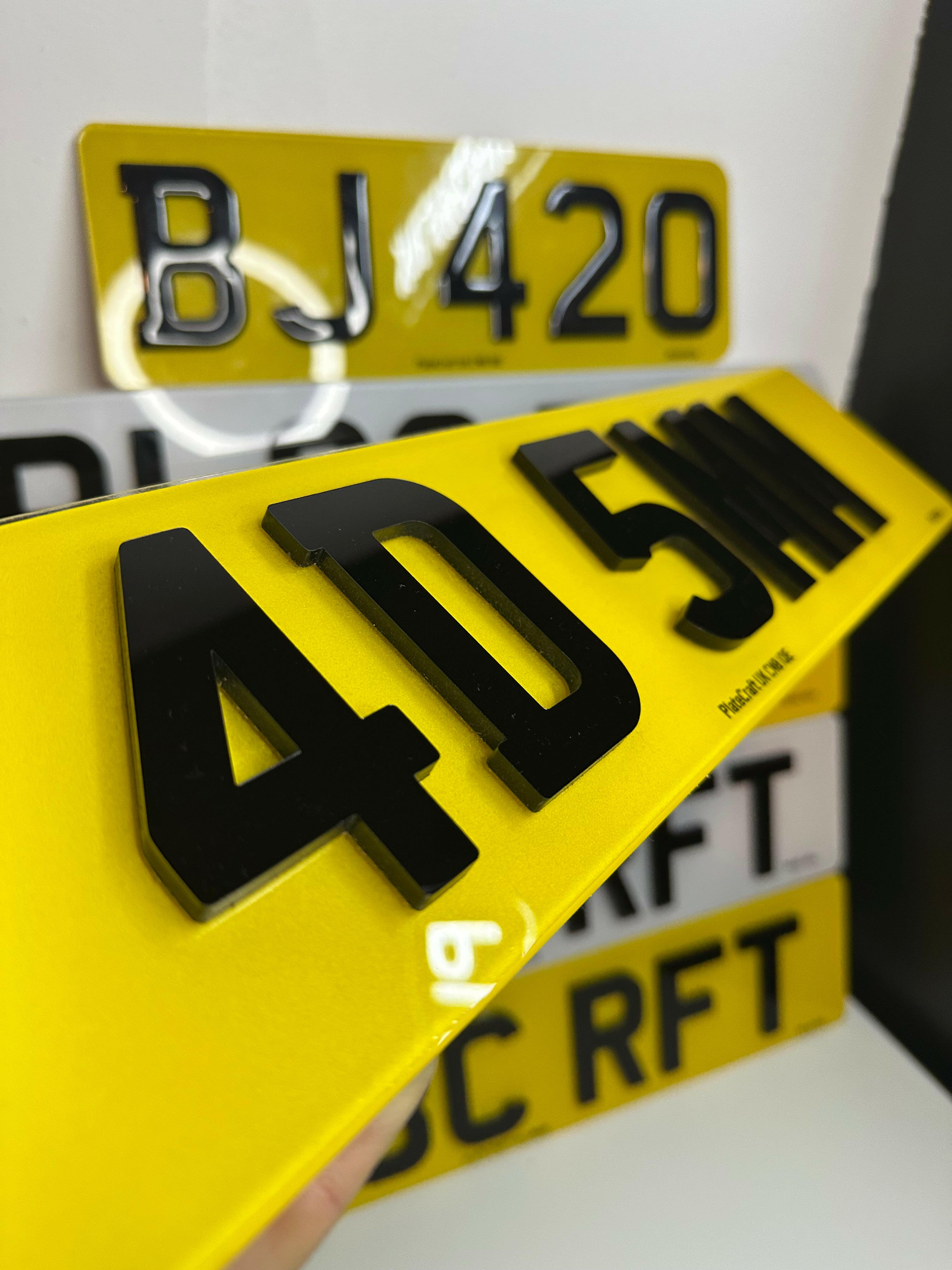 Close-up of 4D 5mm acrylic number plate with bold black raised characters